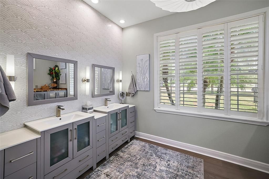 An enlarged custom tiled shower stall and laundry facilities in the Primary Bath.