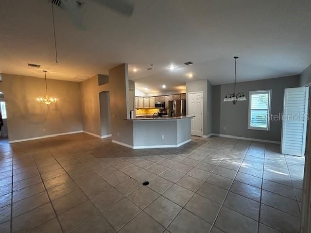 Large Open Floor Plan with Plantation shutters throughout and ceramic tile in hallway, living/Ding area and into kitchen