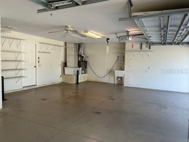 2 car garage with golf cart garage.  Tankless Instant Hot outside the garage area