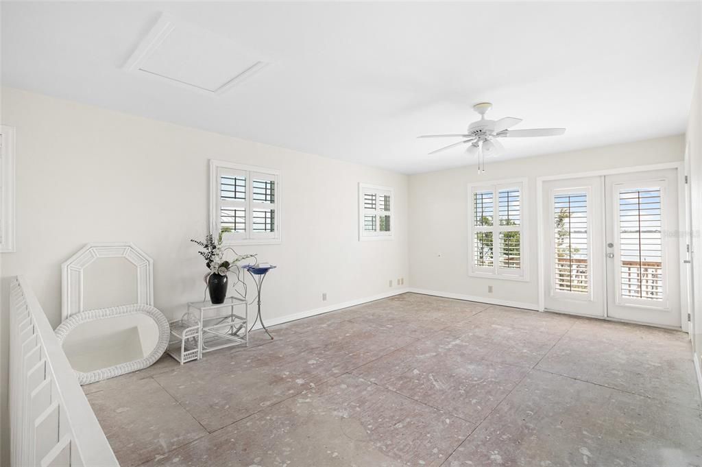 Primary bedroom on the second floor offers french doors leading to deck and bay views!