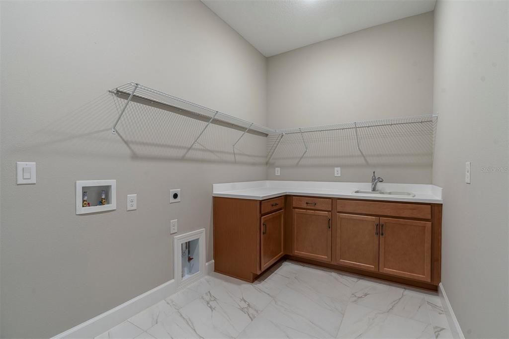 Laundry Room with Cabinets, a Tub and a desk