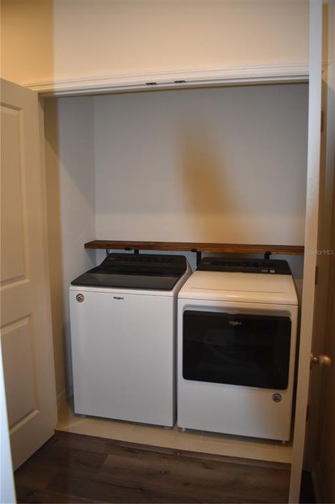 upstairs laundry room with huge closet and farm shelf plenty of storage