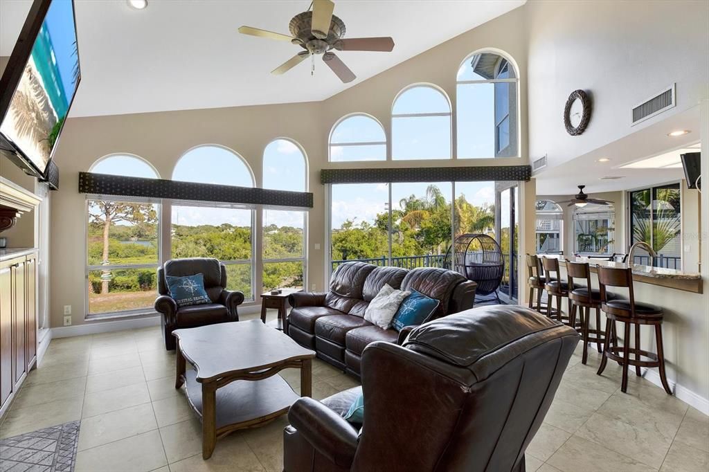 Soaring windows follow you into the open kitchen and family room layout