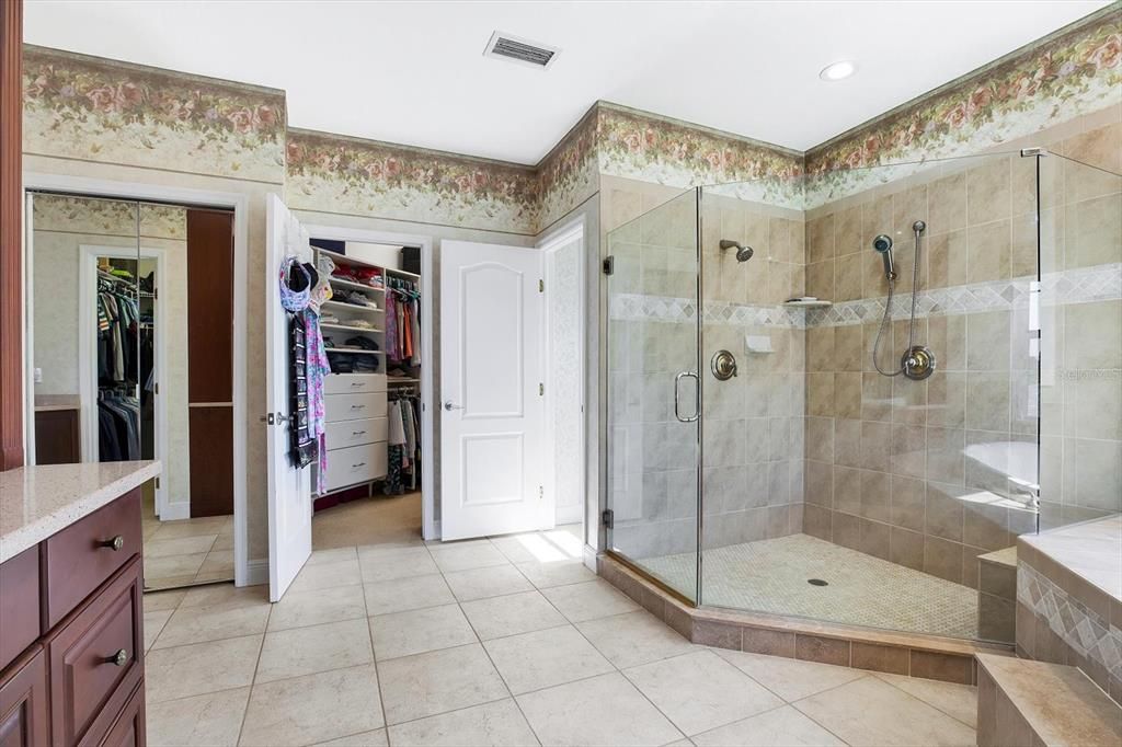 A separate mirrored linen closet and glimpse at one of the walk-in closets