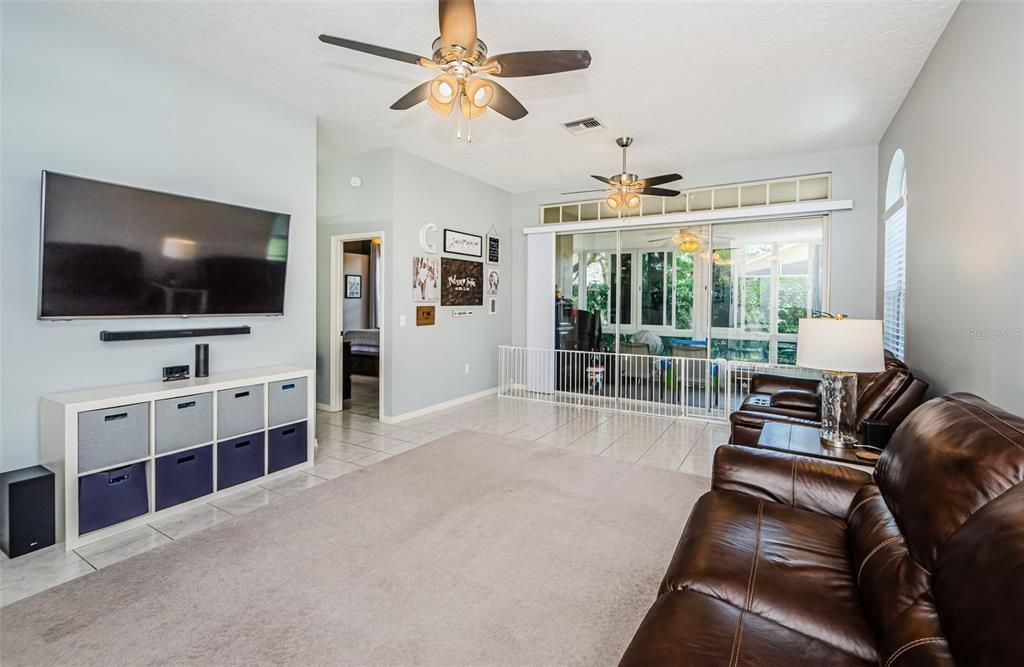 View from front door showing an awesome wall of glass doors leading to glass enclosed and screened porch.