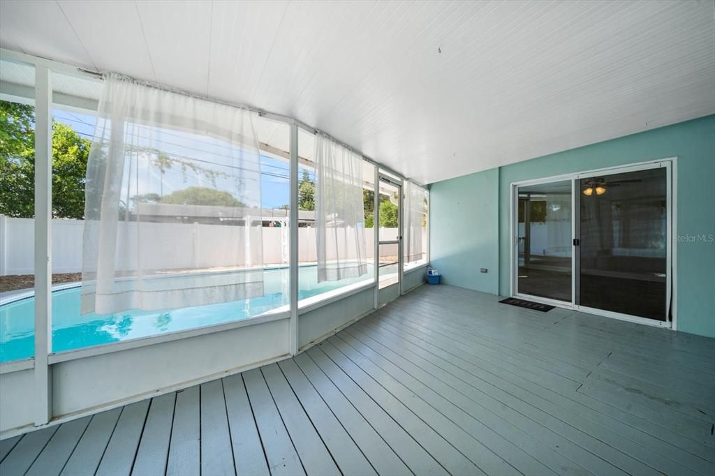 Large screened-in porch leading to pool area