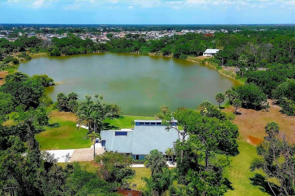 Birdseye view of the front exterior and lake