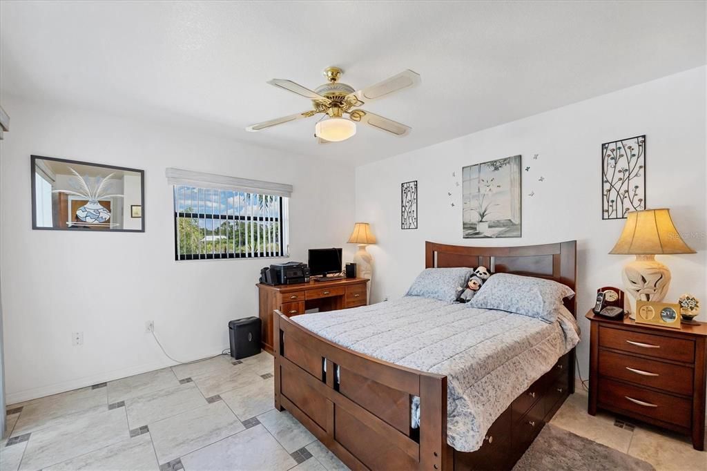 Second bedroom with sliding doors that lead to the pool area