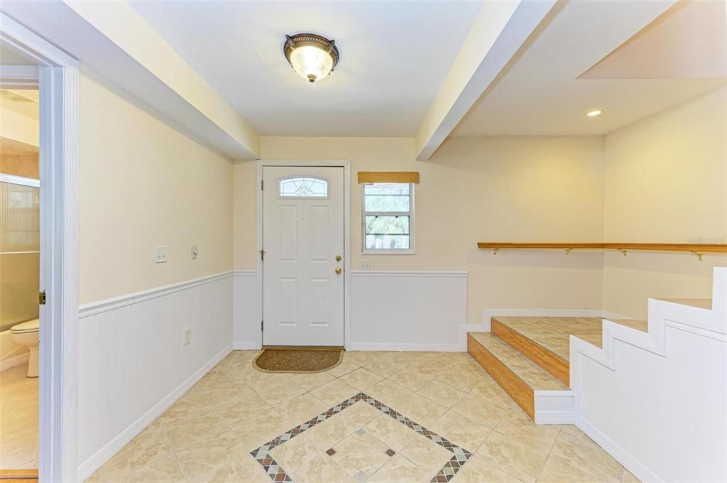 stairway leading to the main living/dining/kitchen and 2 bedrooms