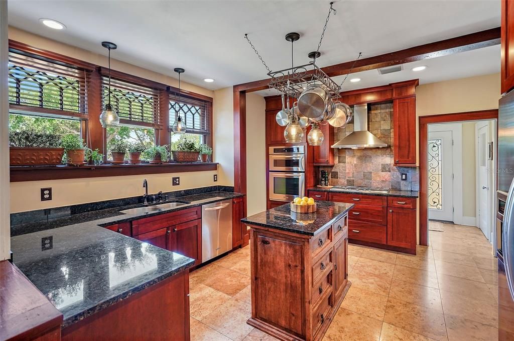 Kitchen details include a pot rack and sunny plant shelf