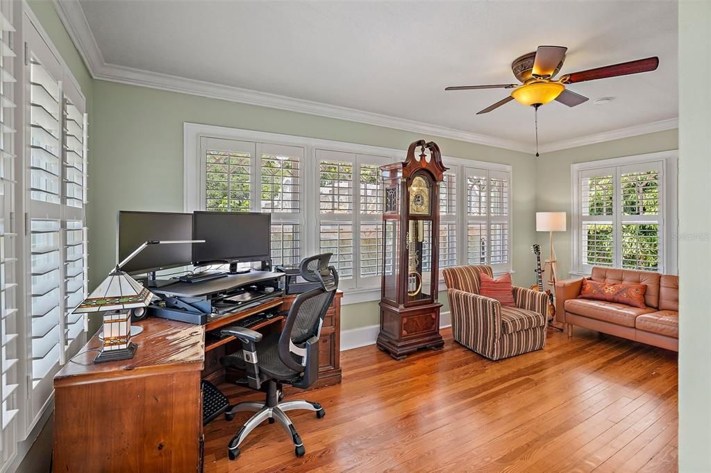 Sunroom off the guest bedrooms serves as an office