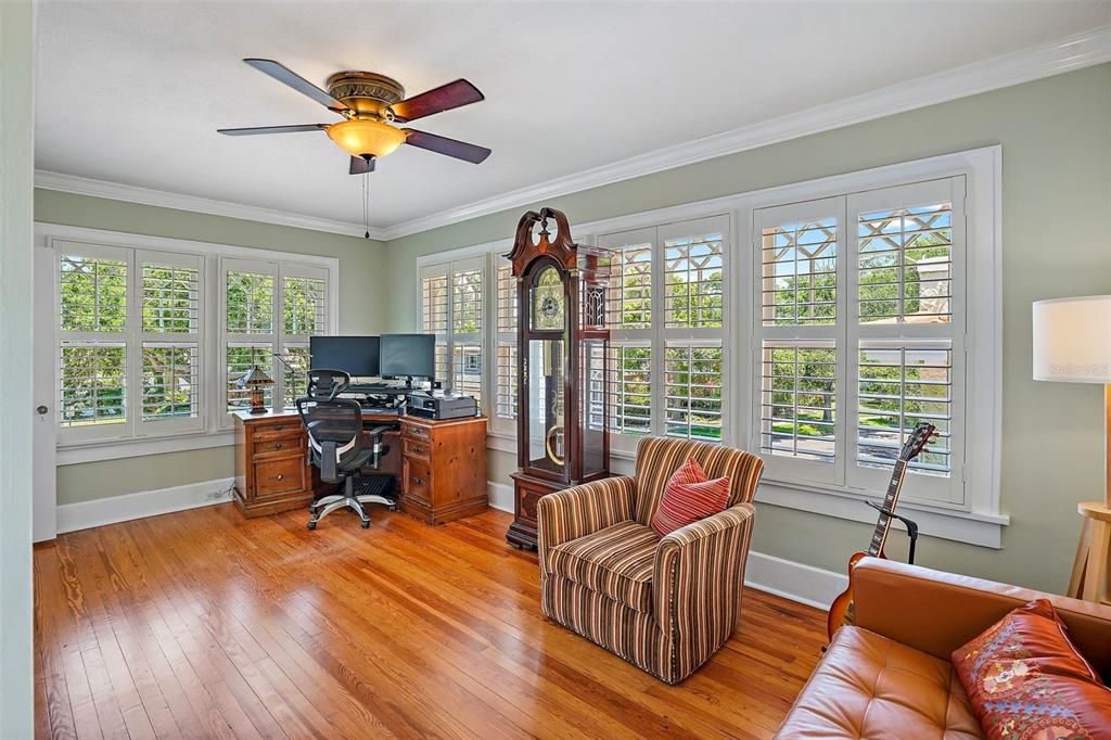 Sunroom off the guest bedrooms serves as an office