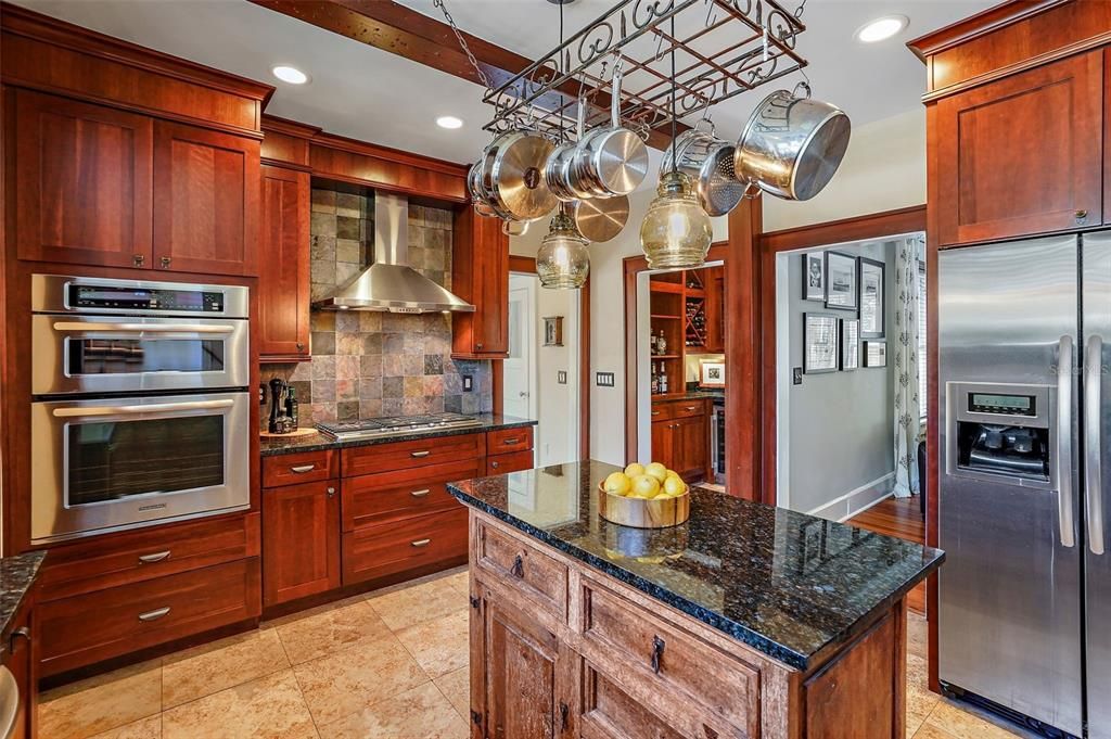 Spacious kitchen with built-in oven, gas cooktop with hood & center island