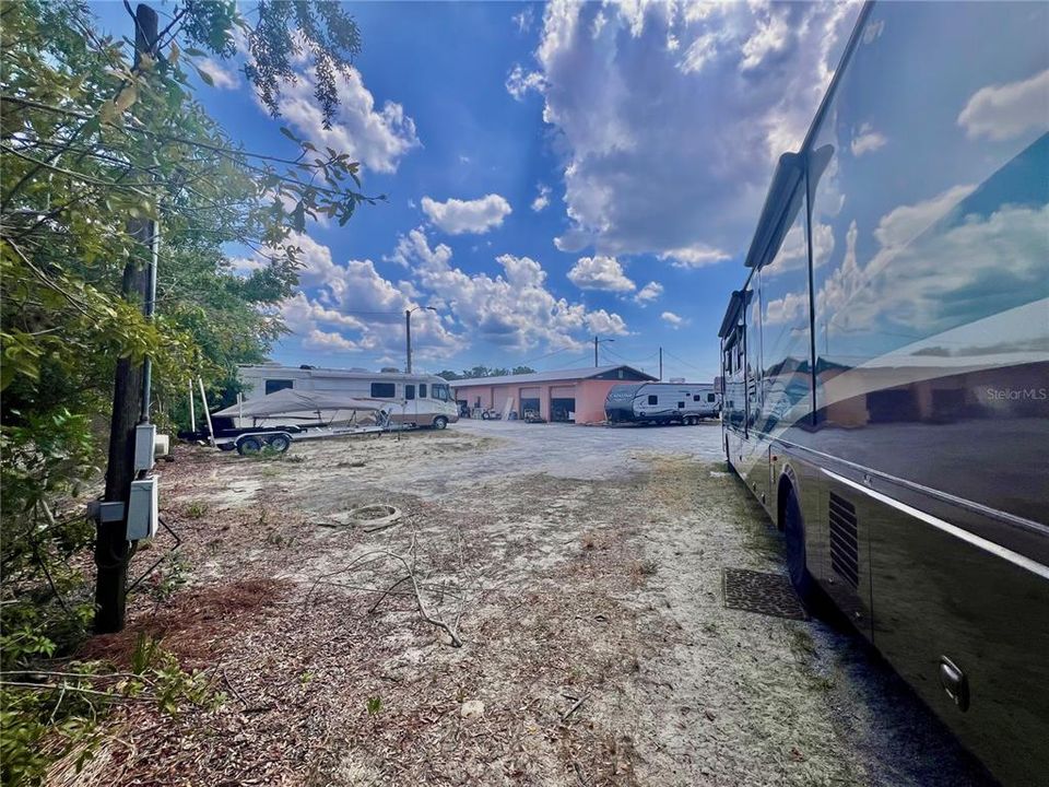 Back right corner of 2nd (vacant) lot towards the building