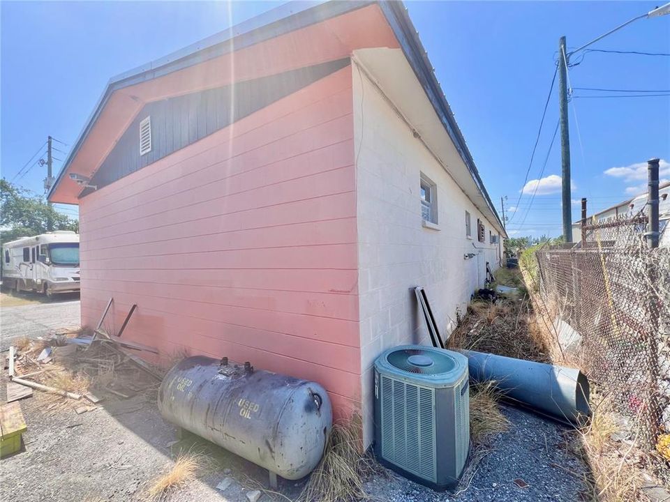 Behind Building shot from rear - above ground oil tank