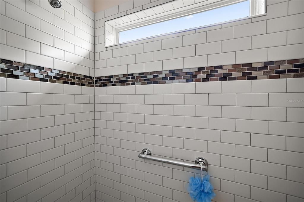 Primary Bath /  Large Roman Shower with grab bars for safety. Upgraded Ceramic Tile & Listellos