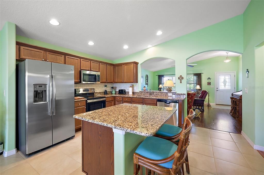 Stainless Refrigerator, Electric Stove, Microwave that is vented to outside of home and Dish Washer & Disposal.Subway Back splash, Stainless Sink. Cabinets are Baywood Oak, Roll out drawers, soft close doors & Drawers.