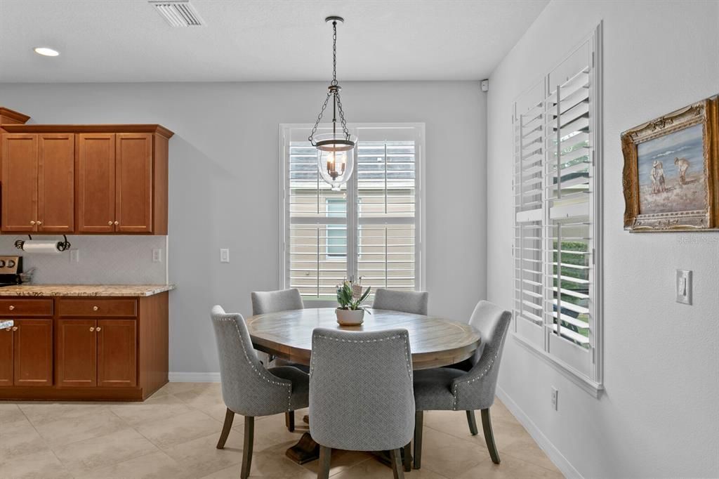 Enjoy casual dining and backyard conservation views from the dinette
