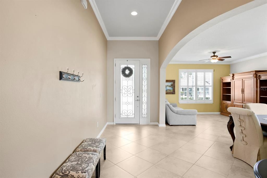 11ft foyer ceilings and a custom glass door welcome you inside the home