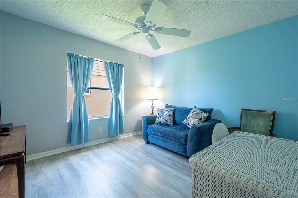 2nd bedroom features luxury vinyl flooring, a built in closet and a ceiling fan.