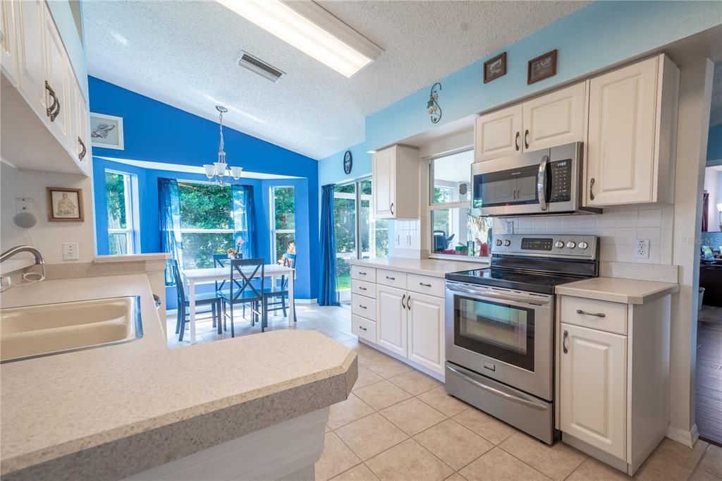 The kitchen features neutral tone corian counters.