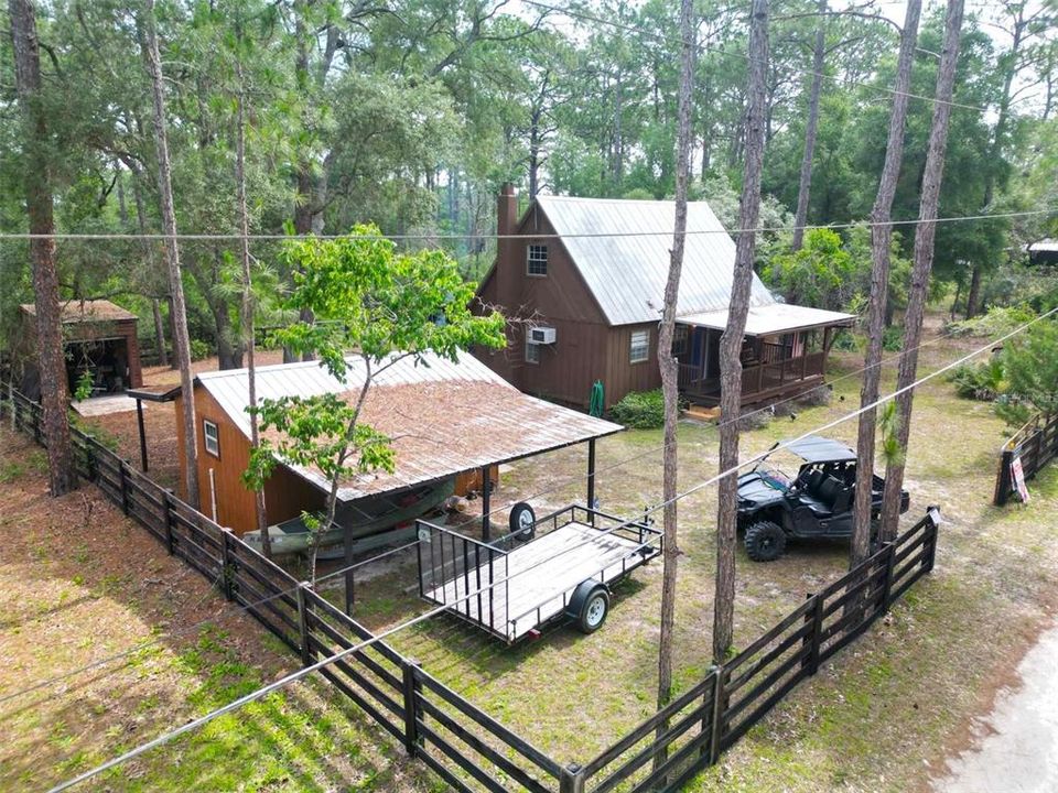 This property has it all! Consists of Cabin, game room, 3 sheds, feeders and fire pit. This all backs right up to $430,000 acres of OCALA NATIONAL FOREST.