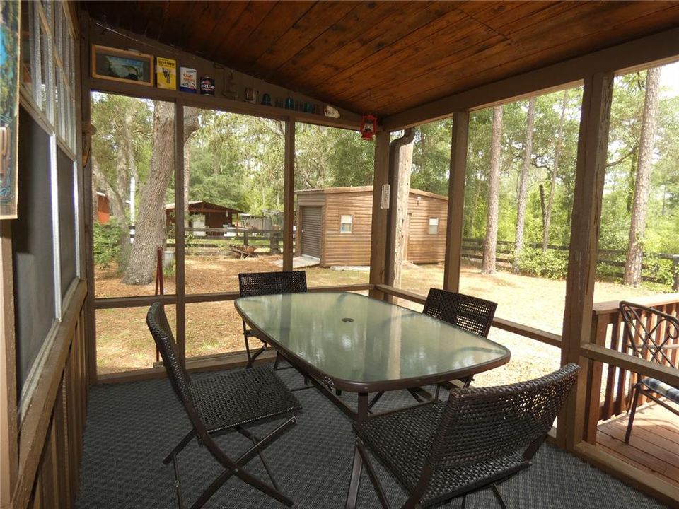 Back full length covered screened in porch.