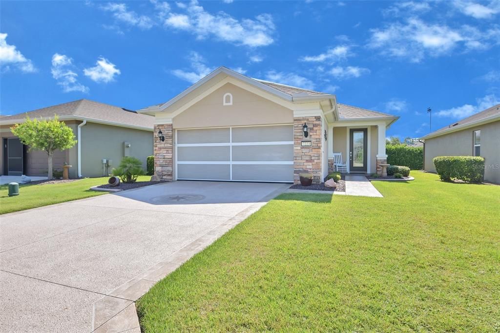 Front View with Premium Screened Garage Door Down with Epoxied Driveway and Walkway