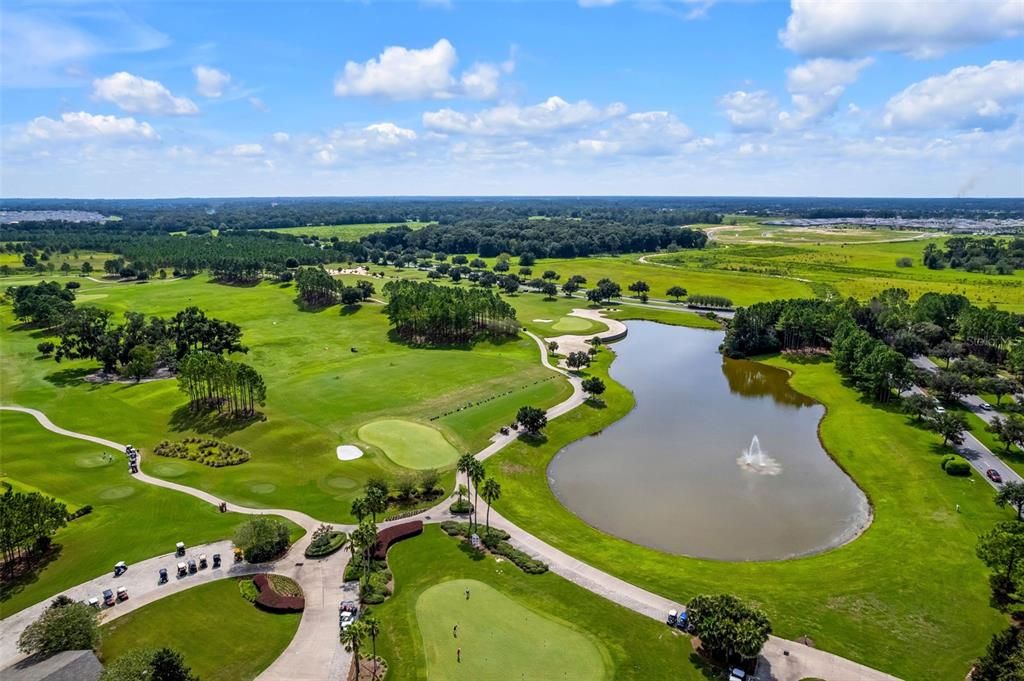 Stone Creek Golf Course Practice Areas and Pond. Tree lined access road (SW 63rd St Rd) at top of photo with Stone Creek Entrance road (SW 89th Ct Rd) on right.