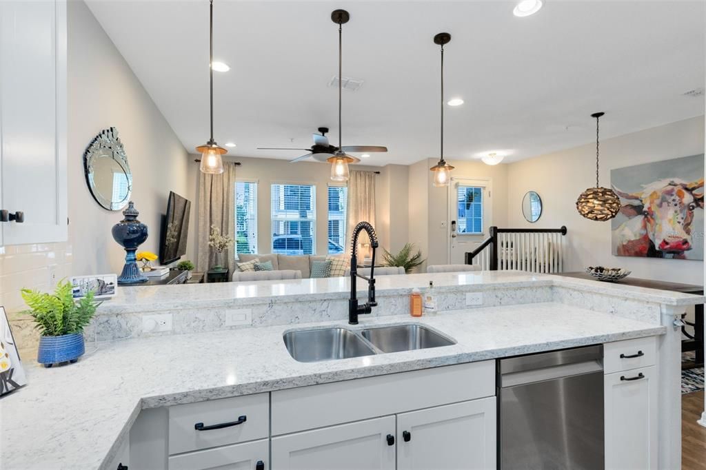 Plenty of counter space, pendant lights, under mount sink & quartz countertops