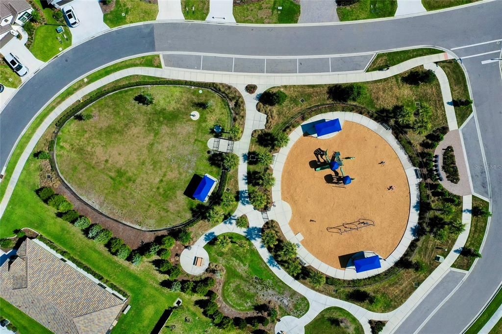 Aerial view of playground, dog park, and community mailboxes.