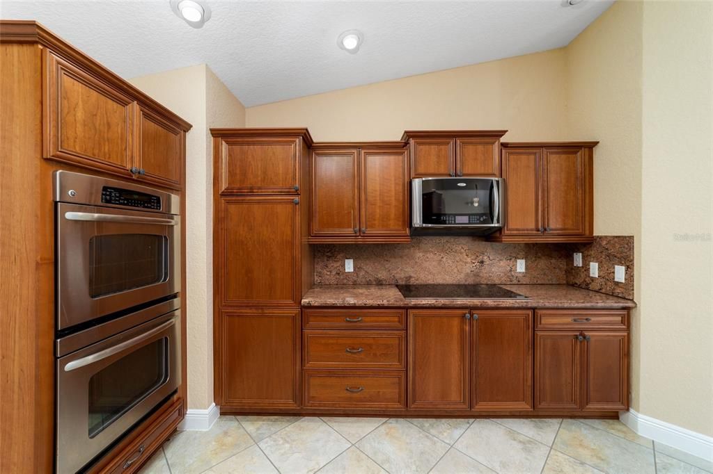 Kitchen with upgraded appliances, Double ovens, stone counters and wood cabinets.