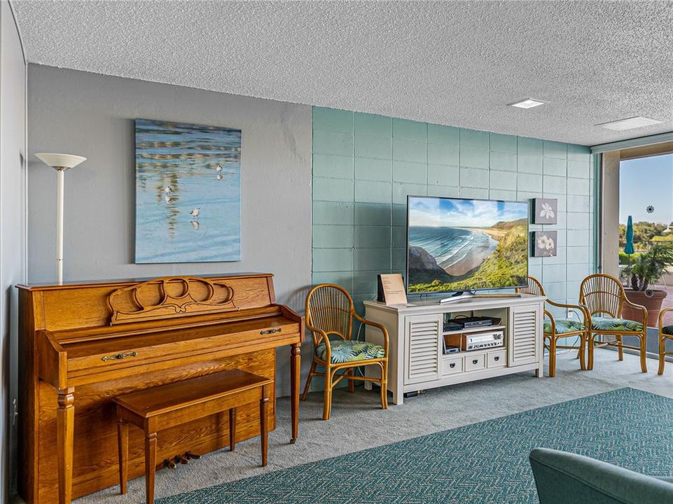 PIANO AND TV IN COMMUNITY GATHERING ROOM