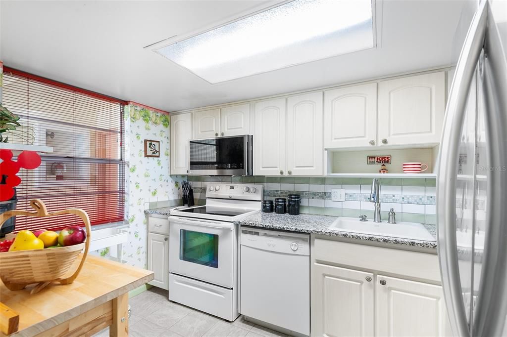 KITCHEN. NOTE ATTRACTIVE CABINETRY, COUNTERTOP AND BACKSPLASH!