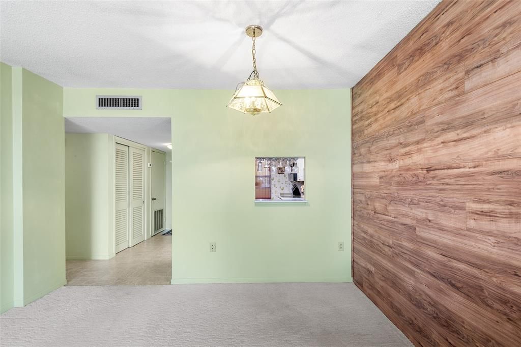 VIEW TOWARDS DINING AREA, FRONT ENTRY AND PASS THRU FROM KITCHEN. NICE STORAGE CLOSET ON LEFT SIDE OF FOYER