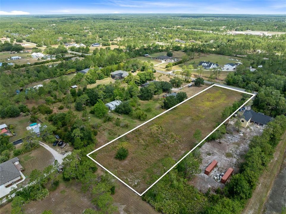Discover the epitome of opportunity with this expansive 2.17-acre vacant lot nestled in the heart of Cape Orlando Estates/Wedgefield neighborhood.