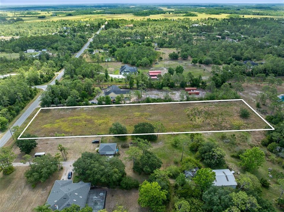 Discover the epitome of opportunity with this expansive 2.17-acre vacant lot nestled in the heart of Cape Orlando Estates/Wedgefield neighborhood.