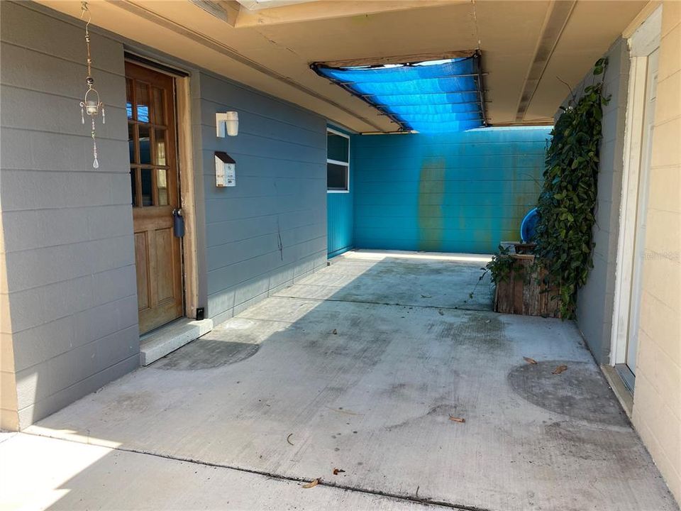 Breezeway from side entry. Garage on right.