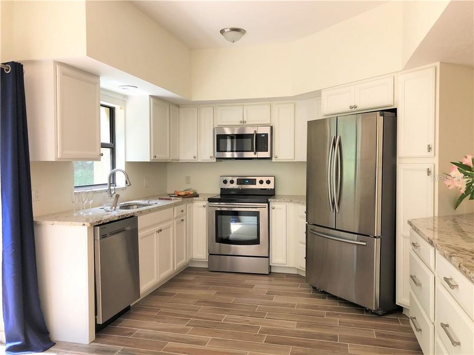Newer stainless steel appliances and wood cabinets