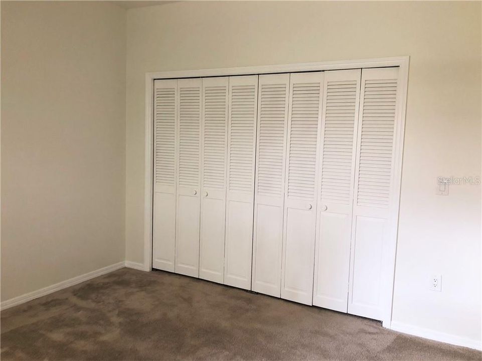 Second bedroom with large wall to wall closet and clean carpet!