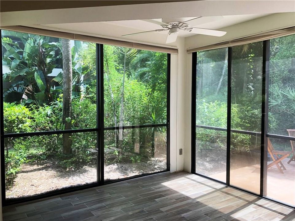 Enclosed lanai with patio and garden views.