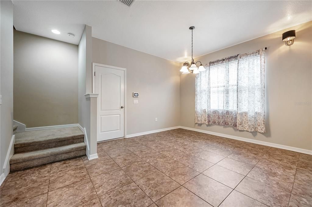 Dinette by the kitchen and stairs leading to the second floor