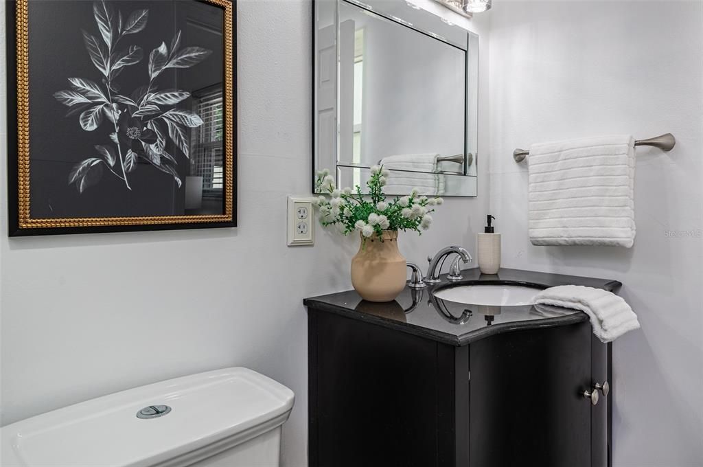 Primary ensuite bathroom with granite vanity and walk-in shower