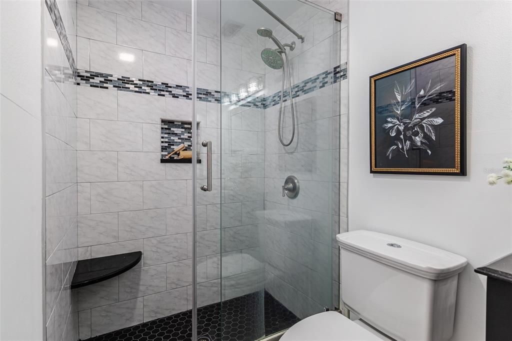 Primary ensuite bathroom with granite vanity and walk-in shower