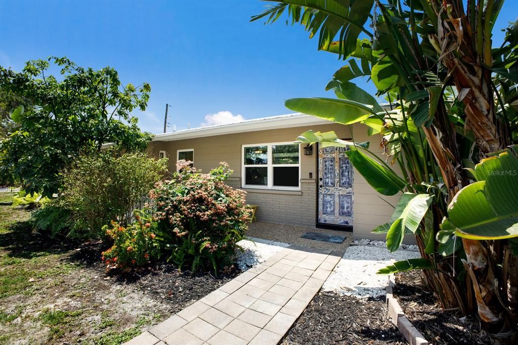 Totally updated yet charming midcentury home tucked inside the lush tropical yard full of flowers and fruit.