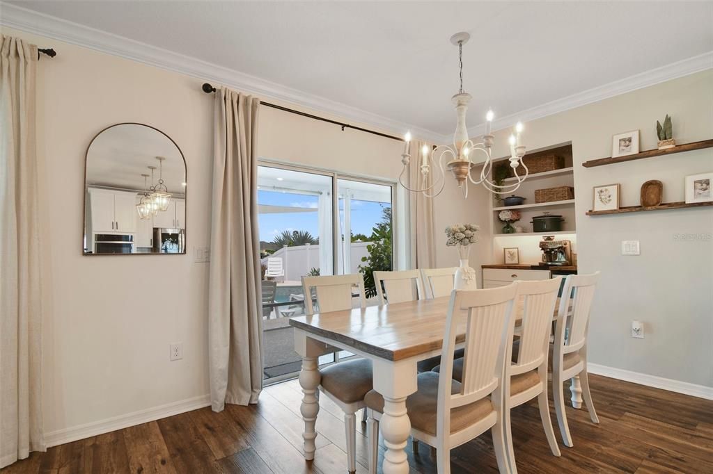 There is an additional dining area sharing space with a CUSTOM BUTLER’S PANTRY/COFFEE BAR and sliding glass door access to the SCREENED LANAI overlooking the SALT WATER POOL!