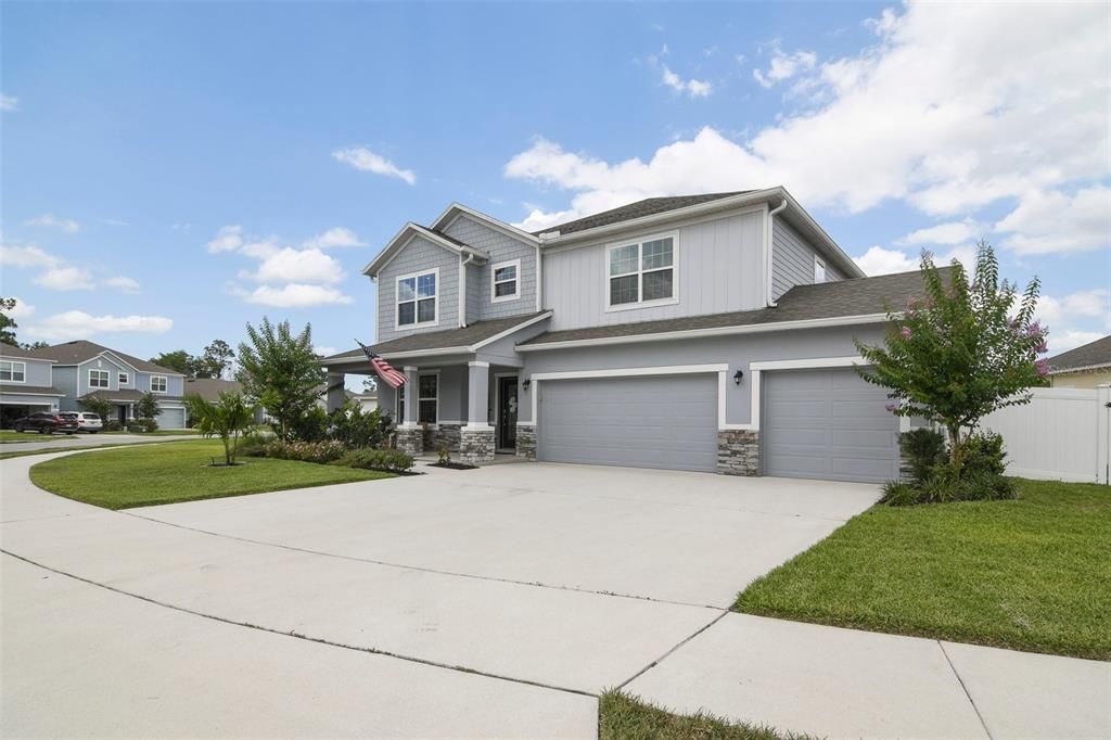 The front elevation of this home exudes charm and the thoughtful landscaping compliments it perfectly while welcoming you home.