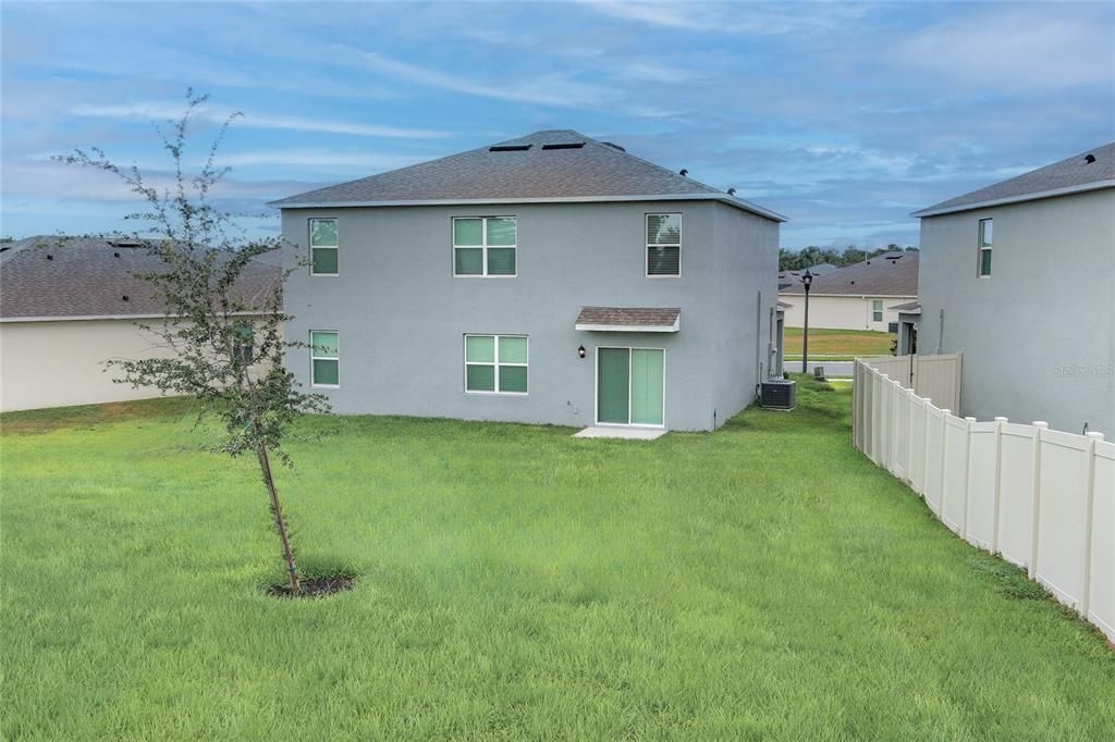 REAR VIEW OF YARD AND EXTERIOR OF HOME - from right