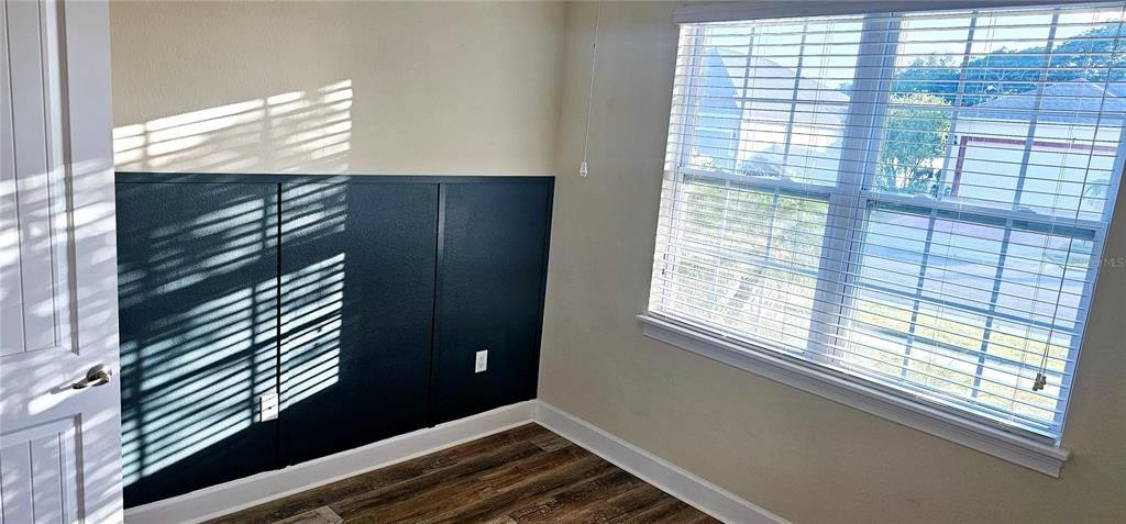 Guest Bedroom 3 with easy-to-clean laminate flooring, and ceiling fan.