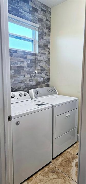 Laundry room with window, washer and dryer.